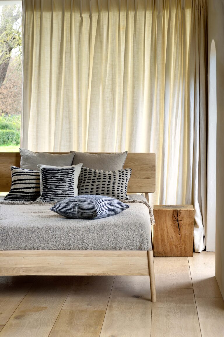 'Air' Ethnicraft bed frame made from wood, featuring a slatted headboard and footboard.