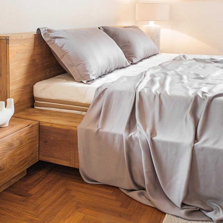 Luxuriously smooth bamboo flat sheets displayed on a bed, showcasing its soft texture and inviting feel.