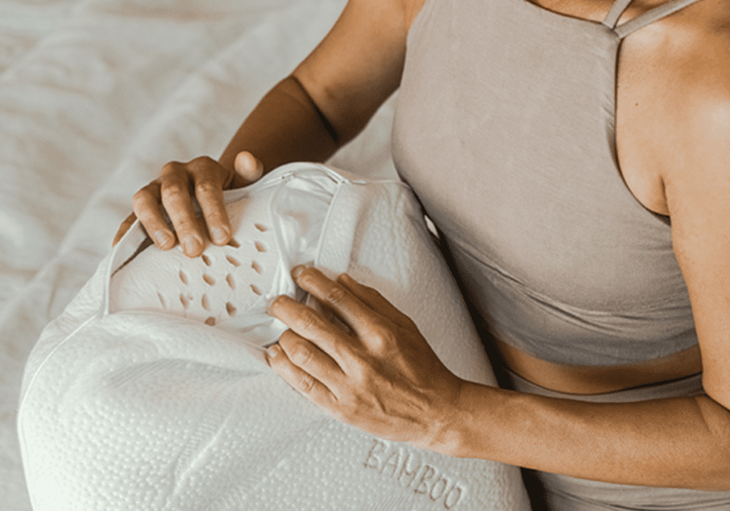 Close-up view of a Heveya® Natural Organic Latex Pillow with its removable bamboo cover open. The soft, breathable bamboo cover offers natural anti-bacterial and anti-fungal properties, and is machine washable for easy care.