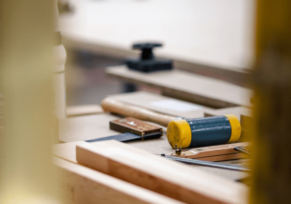 Ethnicraft Dedication to Quality: Close-up of an artisan hand-finishing a solid wood bed frame