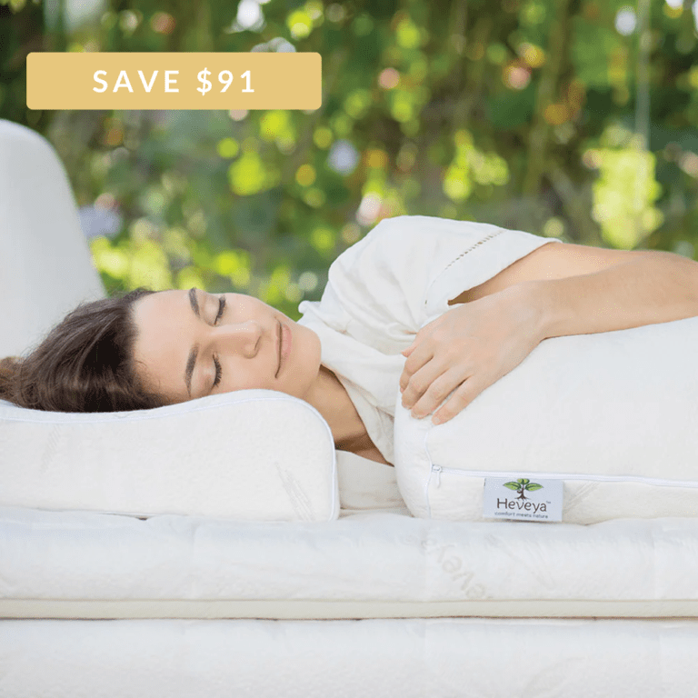 Woman experiencing a comfortable night's sleep with the Heveya® Organic & Natural Latex Pillow Set. This customizable bundle allows you to choose your ideal firmness and shape for personalized comfort and support.